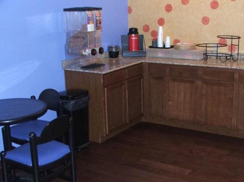 a kitchen with a counter and a table and chairs at Americas Best Value Inn Waco - Franklin Avenue in Waco
