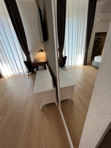 a living room with a table and a mirror at Summertime in Bisceglie