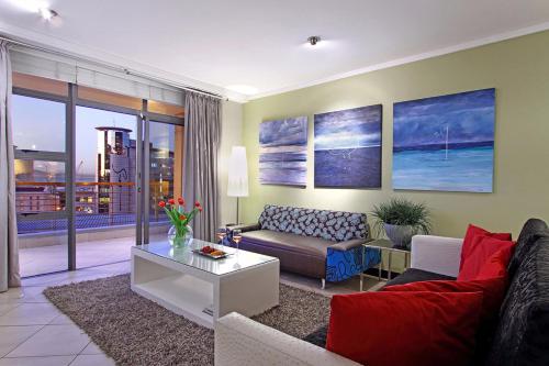 a living room with a couch and a table at Icon Cape Eazi Stayz in Cape Town
