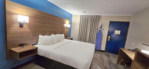 a hotel room with a large bed and a bathroom at SureStay Studio by Best Western Victoria in Victoria