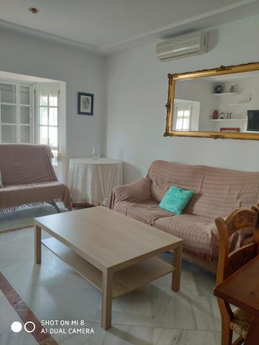 a living room with a couch and a coffee table at VILLA LOS GALLOS in Chiclana de la Frontera
