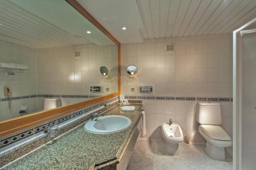 a bathroom with a sink and a toilet and a mirror at Golf Beach Resort - Ultra All Inclusive in Sharm El Sheikh