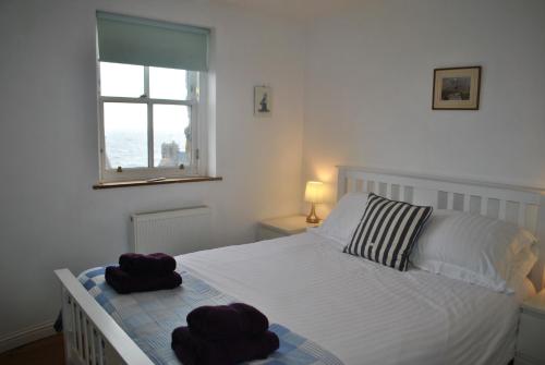 a bedroom with a bed with two towels on it at The Loft- charming character cottage in East Neuk in Anstruther