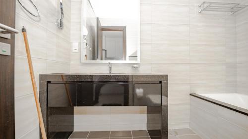 a bathroom with a sink and a mirror at Sleek Studio in Celestia Tower A Dubai South Dubai by Tanami Holiday Homes in Dubai