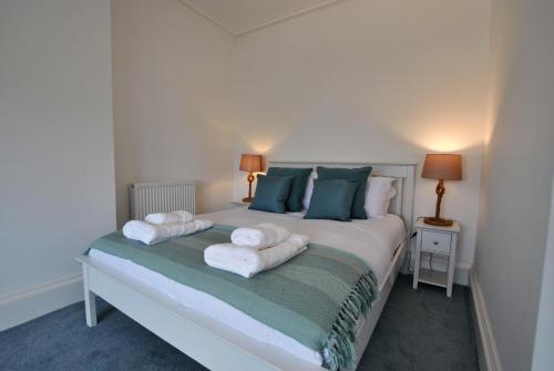 a bedroom with a bed with towels on it at Creel Cottage- stylish cottage near the sea in Anstruther