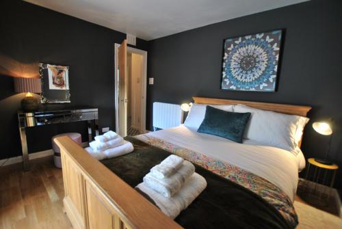 a bedroom with a bed with towels on it at One Shoregate- cosy Crail retreat in Crail