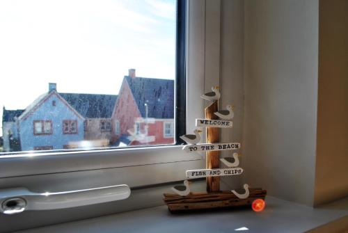 a window sill with a toy next to a window at Forth View- stylish upper apartment with sea views in Anstruther