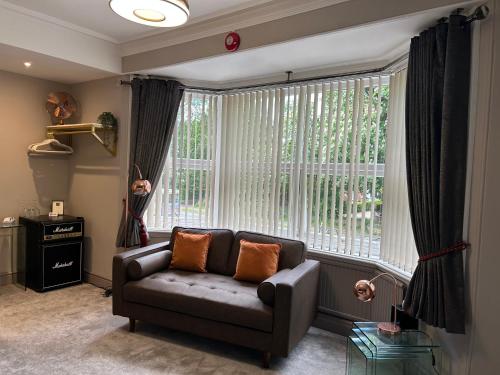 a living room with a couch and a large window at Ashbourne House in York
