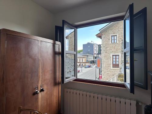 a window in a room with a view of a street at Alojamiento Luz de Hadas in Sampil