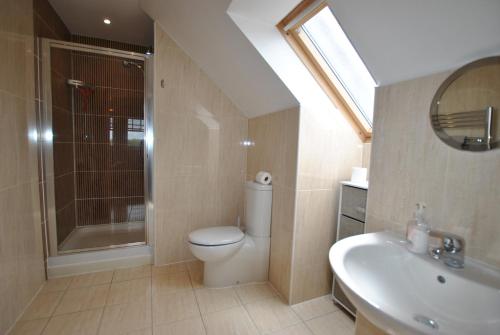a bathroom with a toilet and a shower and a sink at Darnley View- spacious countryside retreat in Crail