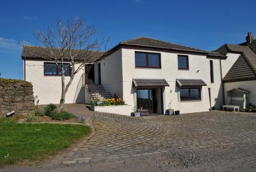 a white house with a brick driveway at Kittle View near Anstruther in Carnbee