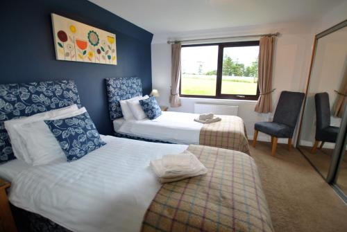 a hotel room with two beds and a window at Kittle View near Anstruther in Carnbee