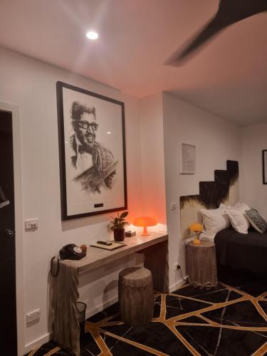 a room with a bed and a desk with a picture on the wall at Circa 1928 in Albury