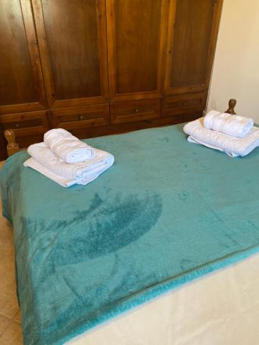 two towels sitting on top of a bed at Mani Spot in Stavri in Stavríon