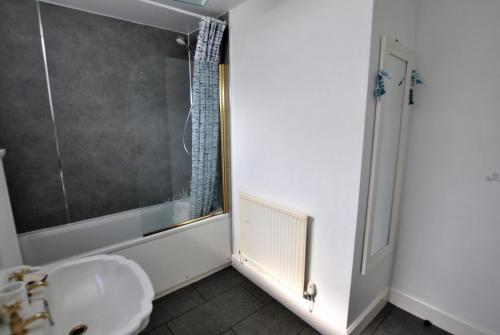 a bathroom with a sink and a shower at Seaglass Cottage-family friendly home in East Neuk in Pittenweem