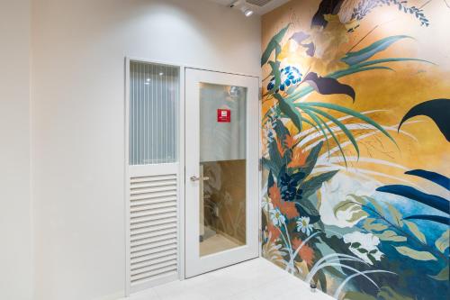 een kamer met een schilderij aan de muur bij Hotel Sanrriott Osaka Hommachi in Osaka
