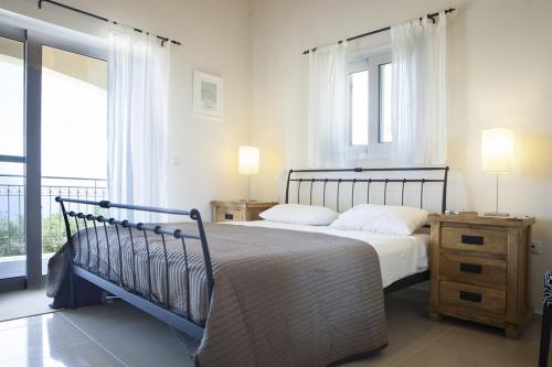 a bedroom with a bed and a large window at Villa Asteri, Old Skala - Secluded Location - Panoramic Sea Views - Infinity Pool in Old Skala