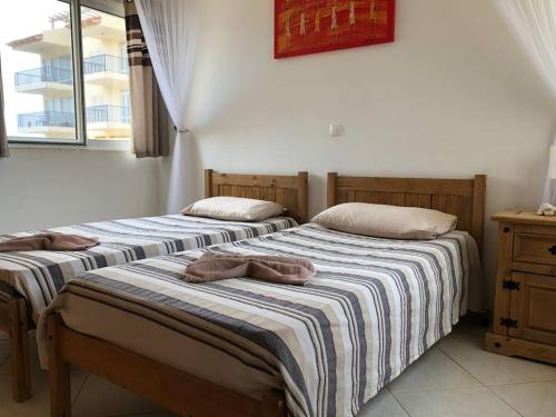 two beds sitting next to each other in a room at Spacious 2 bed Apt with pool & sea views in Sal Rei