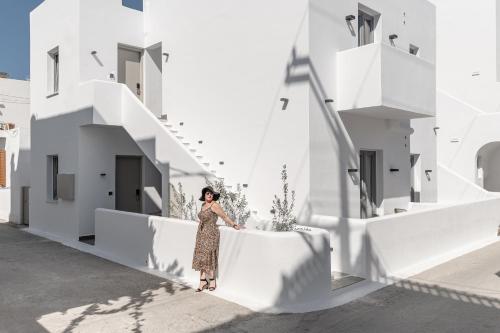 a woman standing on the side of a white building at Argo Boutique Hotel in Naxos Chora