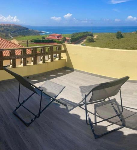 a pair of chairs sitting on top of a balcony at The Globetrotter's Inn in Ericeira