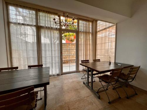 a dining room with a table and chairs and windows at Apartments Zore Dubrovnik in Dubrovnik