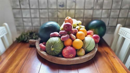 a bowl of fruit sitting on a wooden table at Shrinath Yog Temple in Langenfeld