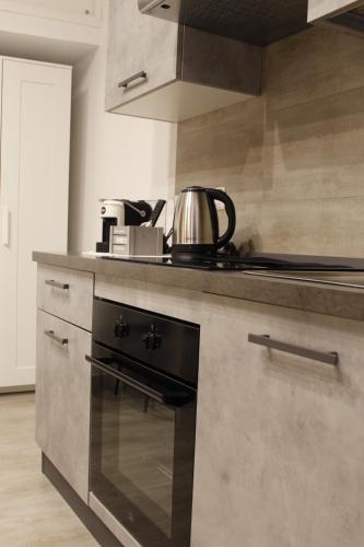 a kitchen with a stove with a tea kettle on it at La pergola home in Barletta