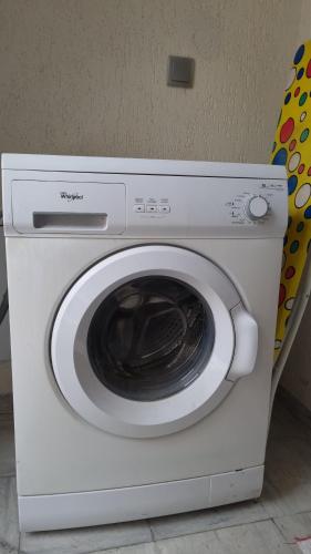 a white washing machine sitting in a room at Le luxe de ain zaghouan in Sidi Daoud