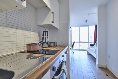 a kitchen with a stove and a counter top at For Students Only Exquisite Modern Studios at Upperton Road in Leicester in Leicester