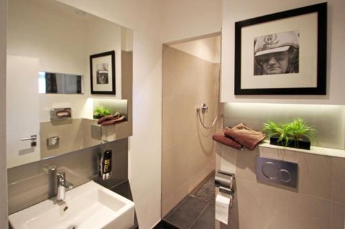 a bathroom with a sink and a mirror at Hotel & Restaurant Eggers GmbH in Sprockhövel