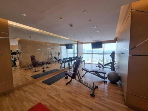 a gym with treadmills and exercise equipment in a building at Tranquil Studio in Damac Hills in Dubai