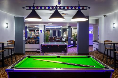 a pool table in a room with a pool at Airport Hotel Manchester in Manchester