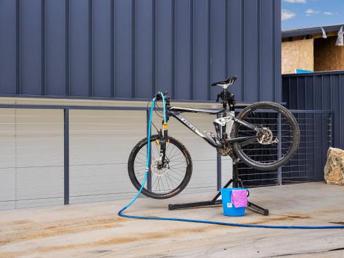 a bike on a stand with a hose attached to it at Luxury 5 Bedroom Home - Sentinel Chalet - Snowy Mountains - Jindabyne in Jindabyne