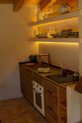 a kitchen with a sink and a stove top oven at Santa Llúcia Rupit in Rupit