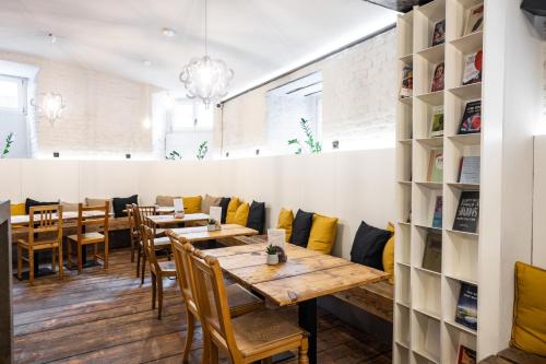 a dining room with wooden tables and chairs at Sophie's Hostel in Prague