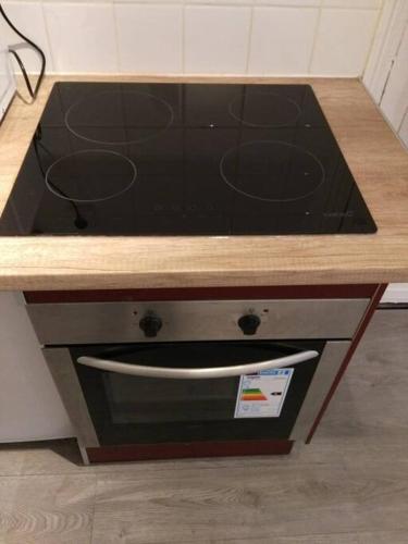 un four avec plaques de cuisson et comptoir en bois dans l'établissement Comfortable & bright Parisian studio!, à Ivry-sur-Seine