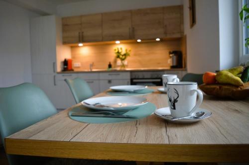 a wooden table with plates and cups on top of it at Alpenflair in Berwang