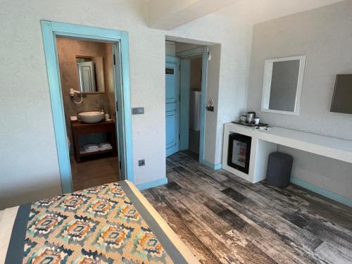 a room with a bed and a fireplace in it at Villa Oliva Butik Hotel in Bodrum City