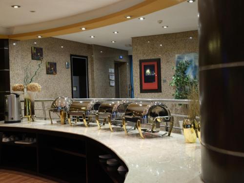 a salon with a row of chairs on a counter at Boudl Salmiya, Kuwait - بودل السالمية الكويت in Kuwait