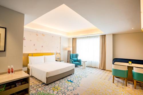 a hotel room with a bed and a desk at Holiday Inn Lucknow Airport by IHG in Lucknow