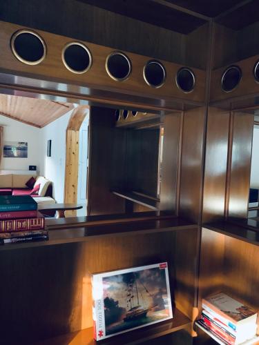 a living room with a room with a ship in a mirror at Nadia's Beach House in Pefkari