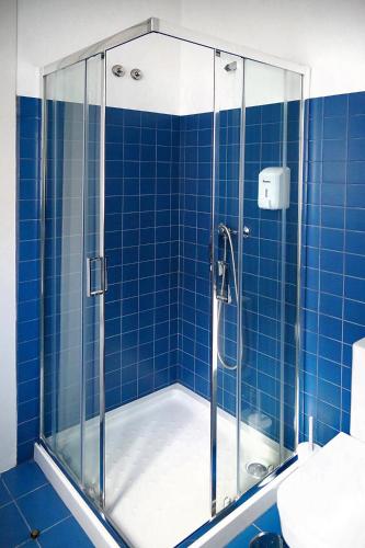 a bathroom with a shower with blue tiled walls at Citybreak-apartments Bolhao in Porto