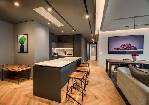 a kitchen and living room with a bar and a couch at The Rockefeller Hotel by NEWMARK in Cape Town