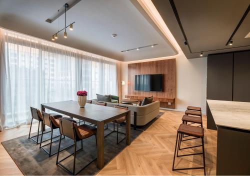 a living room with a table and a couch at The Rockefeller Hotel by NEWMARK in Cape Town