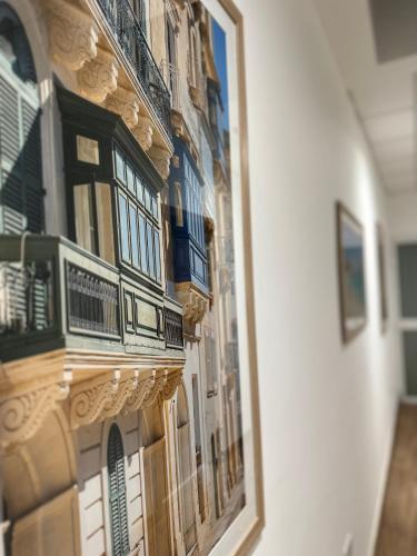 a reflection of a building with balconies in a mirror at The Beach House in Birżebbuġa