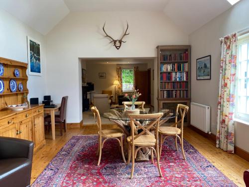 a dining room with a table and chairs at Spacious cottage - walk to Crieff in Crieff