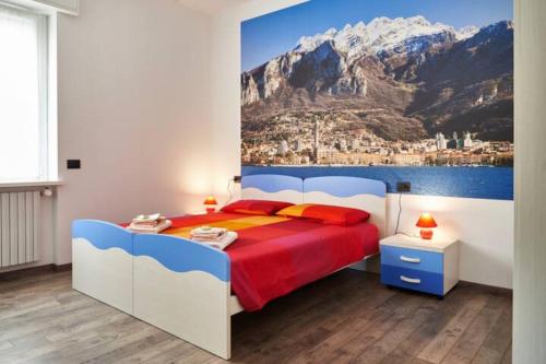 a bedroom with a bed with a painting of a mountain at Grandi Cime Guest House in Lecco