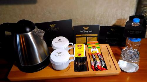a table with a coffee pot and some products on it at TAC MAHAL HOTEL in Ankara