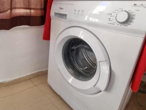 a white washing machine sitting in a room at Le luxe du Lac in Tunis