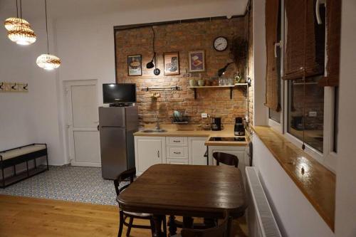 a small kitchen with a table and a refrigerator at Central Park Apartment in Cluj-Napoca